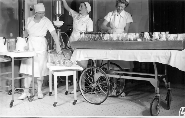 Three nurses preparing materials in the O.R.