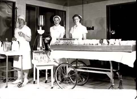 Three nurses preparing materials in the O.R.