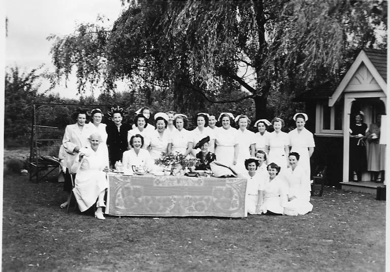 Miss Erskine (Director) and Miss Eastley (assistant) on left at the table. Nonie in centre, above lady with black hat.