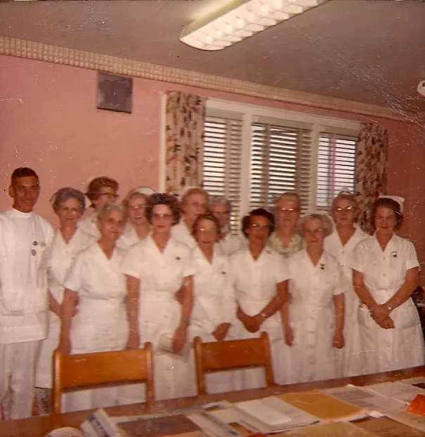 Doctor's Library on occasion of Miss Draften's (English nurse) last day at Pearson Hospital. Presentation of pin and book on Canada. Nonie pictured on right.